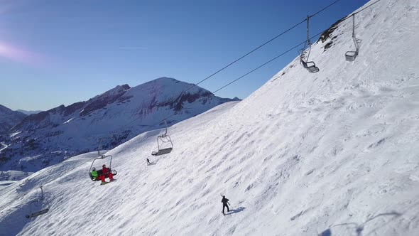 Drone Aerial Ski Couple Sitting on Chair Lift