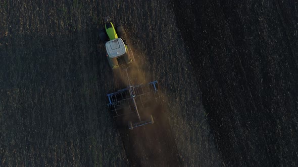 Aerial View the Tractor Plows the Earth
