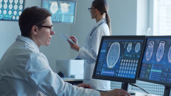 Professional medical doctors working in hospital office making computer research.