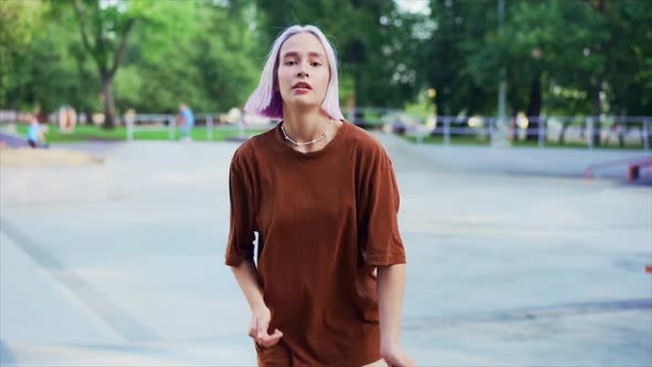 Young Dancing Teenager Girl Enjoying Funky Hip-hop Moves. Modern Woman with Violet Dyed Hair