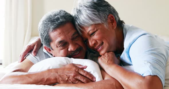 Senior couple embracing each other in bedroom 4k