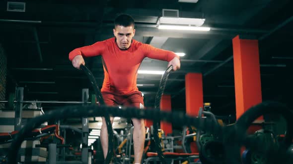 One Man Uses Battle Ropes During Crossfit Training