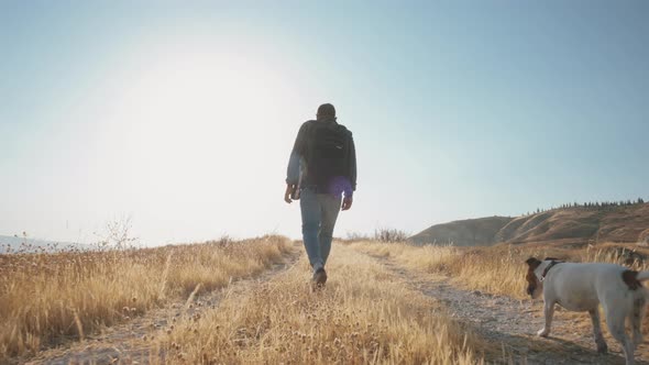 Back view of a man with backpack walk