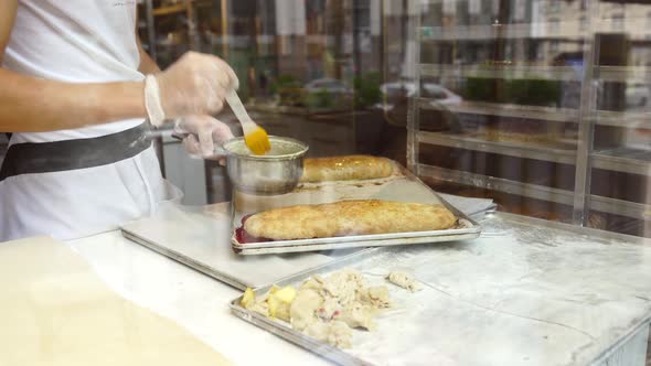 A Man Prepares an Apple Strudel for Sale