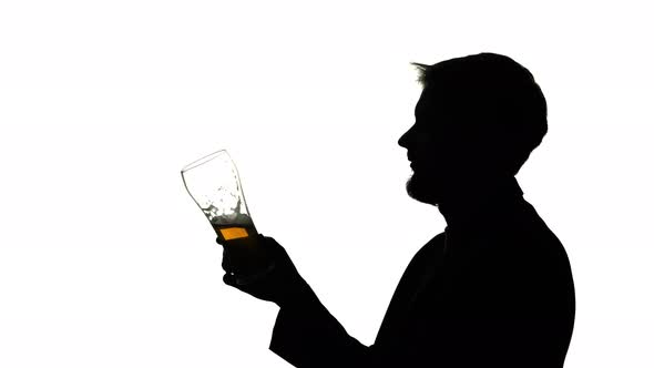 Guy Drinks Beer From a Glass, Side View, Silhouette White Background