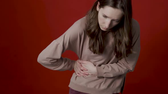 A Young Caucasian Woman Has Pain in Her Lower Back