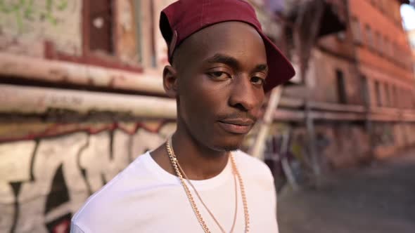 Portrait of a young black guy on the street in the ghetto