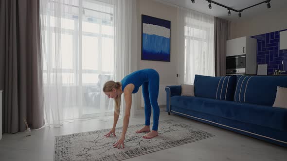 A Woman at Home Does Exercises Without Leaving Home