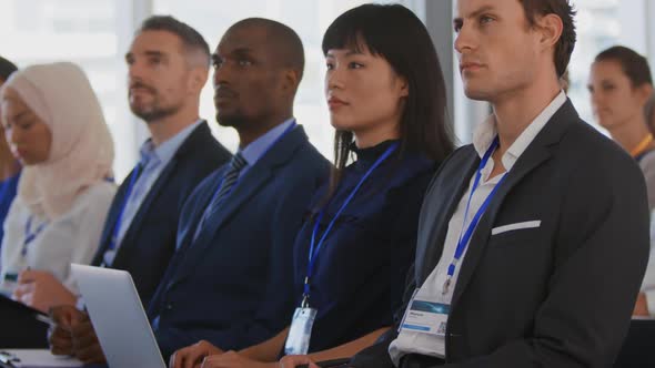 Audience at a seminar raising hands to ask questions