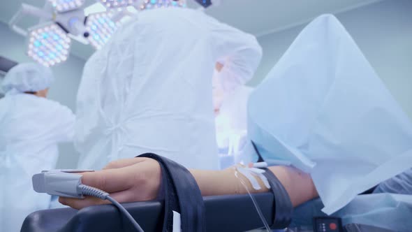 Medical Team Performing Surgical Operation in Bright Modern Operating Room