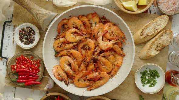 Traditional Fried Tiger Prawn with Garlic Bread As Top View Served in a White Frying Pan