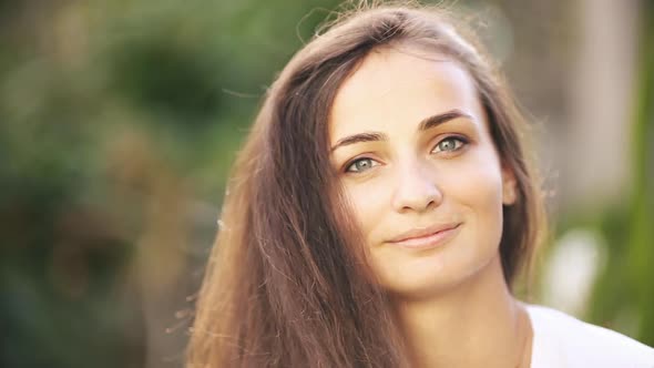 Portrait of Beautiful Caucasian Woman Smiles and Enjoys of the Moment Isolated on Blur Background