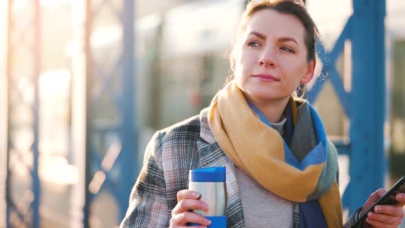 Portrait of a Young Caucasian Businesswoman in a Coat Walking Around the City on a Frosty Morning