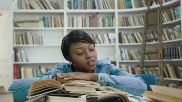 Tired African Female Student Girl Lying on the Books