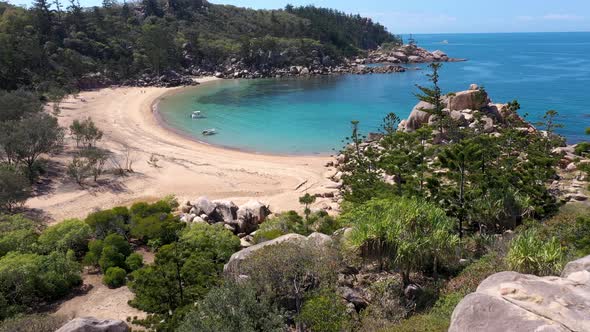 Magnetic Island Arthur Bay beautiful beach aerial reveal above trees, Queensland