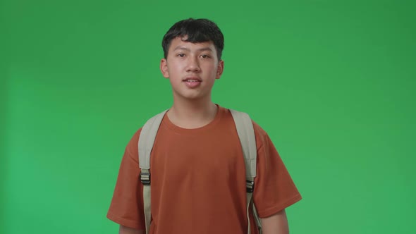 The Front View Of Asian Boy Student Walking To School On Green Screen Chroma Key