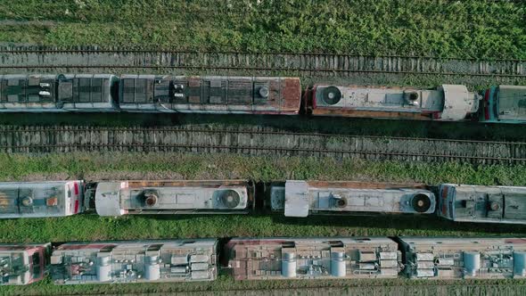 Aerial Top Down Shot of an Abandoned Rusty Locomotives and Old Railways