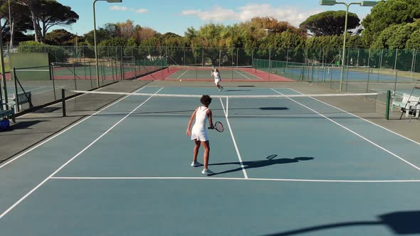 Video of top view of diverse female tennis players on court during match