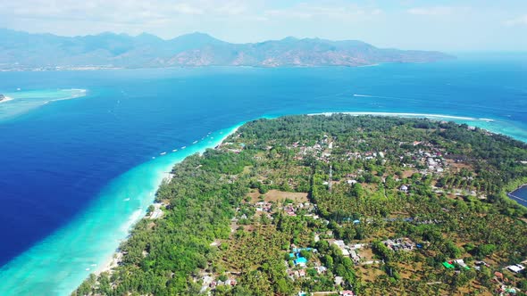 Wide angle birds eye clean view of a sandy white paradise beach and blue water background in hi res 