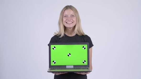 Young Happy Blonde Woman Showing Laptop and Looking Surprised