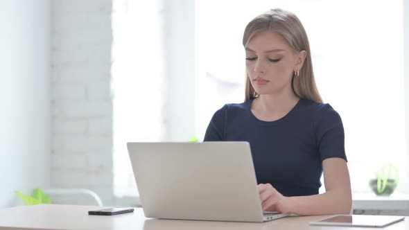 Busy Woman Typing on Laptop in Office