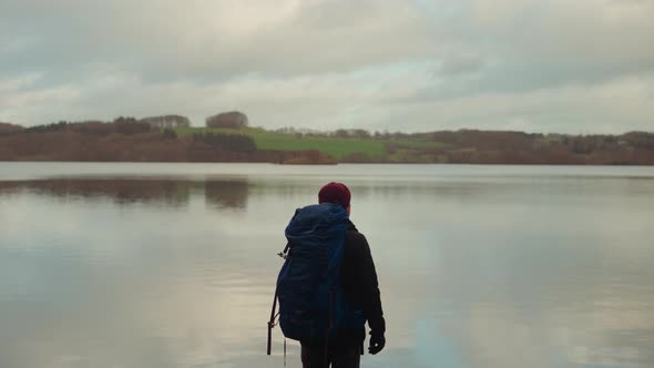 Tourist with Huge Backpack Stands By the Lake in Himmelbjerget Area Denmark