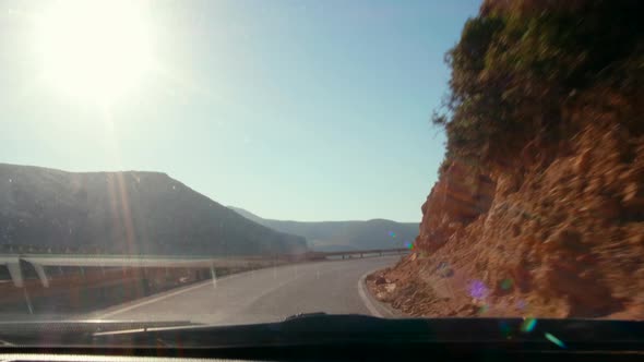 Driver's POV of Road Trip on Serpentine Asphalt High Way in Mountains and Sea