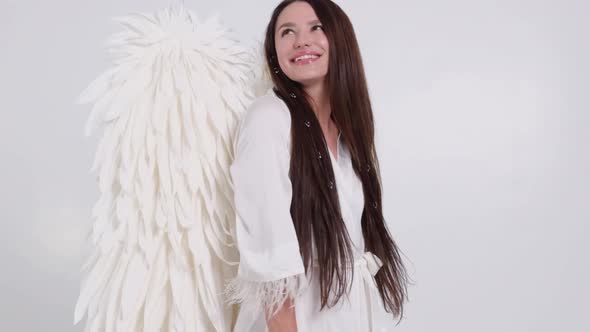 Slow Motion Girl with Angel Wings on a White Background