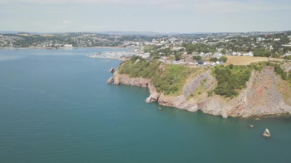 Aerial view of the coastal town and harbour of Torquay England. Coastline and beach front is visible