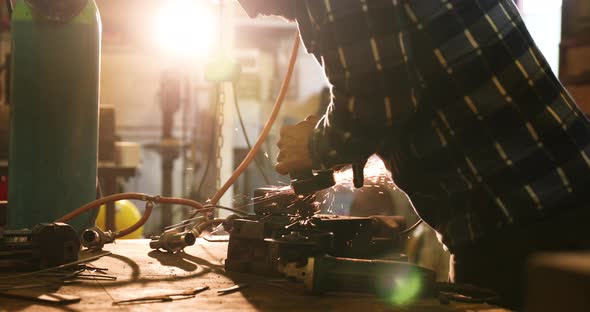 Bladesmith working with angle grinder