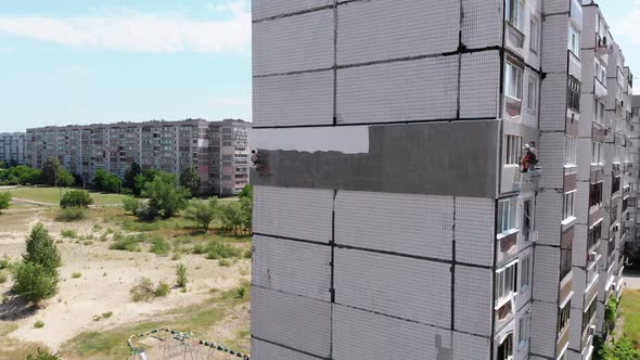 Aerial View Two Industrial Climbers Perform Work on Insulation Facade Building