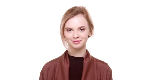 Young Teenager Beautiful Girl Standing on White Background and Smiling at Camera in Slowmotion