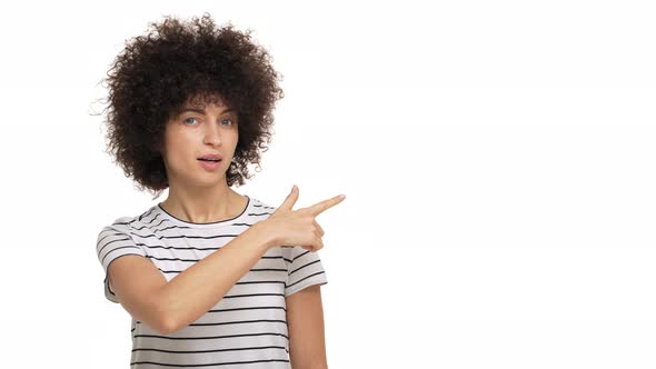 Portrait of Female Person Having Afro Hairstyle Pointing Index Finger Looking at Something with