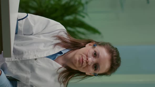 Vertical Video Pov of Botanist Woman in White Coat Listening Chemists Team During Online Videocall