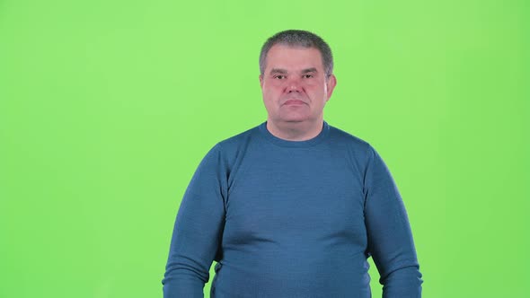 Man Is Not Emotional Standing in the Studio. Green Screen. Slow Motion