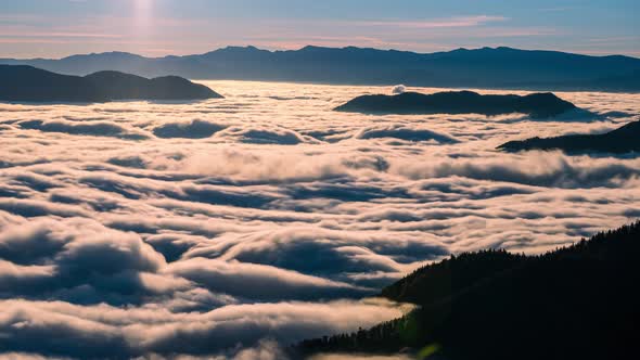 Low Clouds Flow Like a River in Alpine Mountains Valley in Beautiful Autumn Nature Landscape