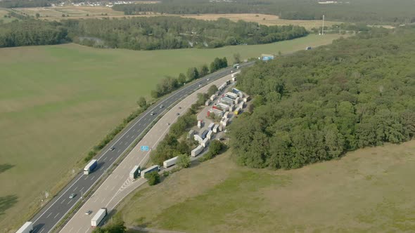 Aerial Shot of Freeway in Fields with Truck Parking