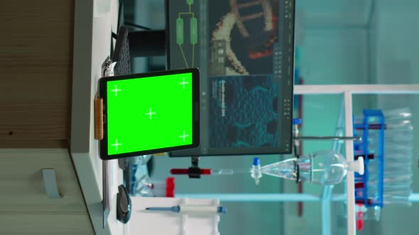 Vertical Video Tablet with Green Chroma Key Screen Placed on Desk in Lab