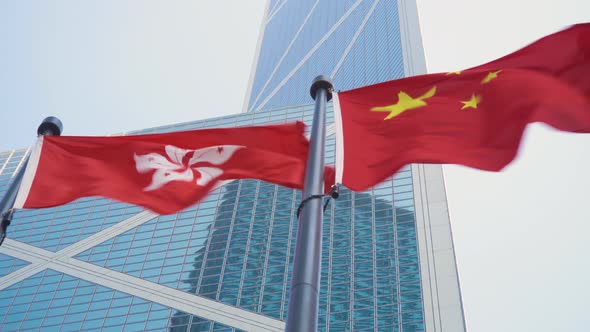 Hong Kong and China Flags With Business Office Tower on the Background