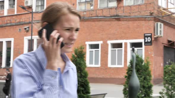 Walking Woman in Anger Talking on Phone
