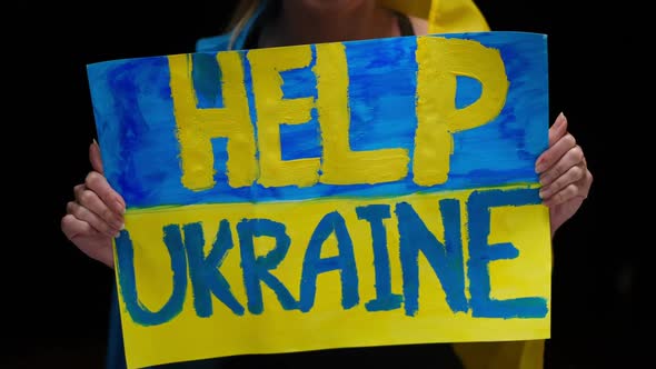 Closeup Help Ukraine Banner in Shaking Female Slim Hands