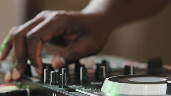 Closeup Unrecognizable DJ Man African Male Finger Using Mixer Controller Desk in Club Musical Studio