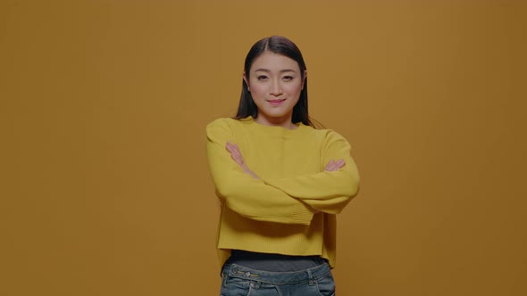 Portrait of Asian Woman Standing with Arms Crossed