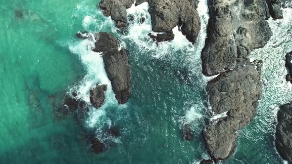 Aerial Top View of Sea Waves Crushing Into the Rocks Near Beach