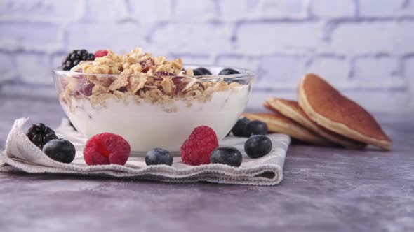 Yogurt Granola and Berries in Bowl on Black Background