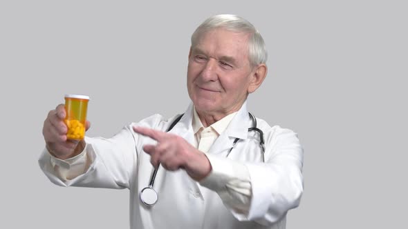 Smiling Old Senior Doctor with Pill Can and Thumb Up.