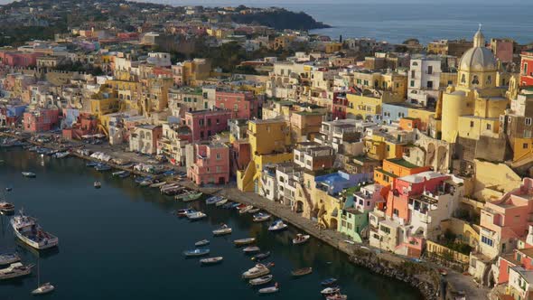 Zoom Out Shot Island of Procida. Naples, Italy. Fishing Village with Colorful Houses and Boats in