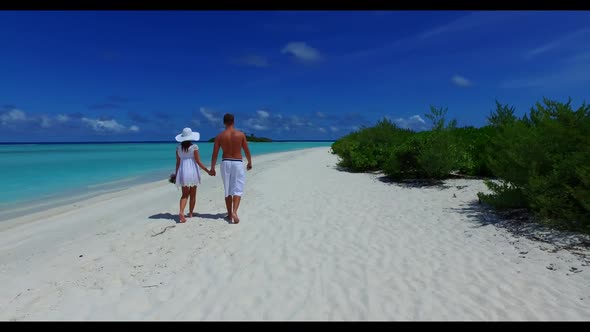 Two lovers tan on perfect resort beach break by clear ocean and white sand background of the Maldive