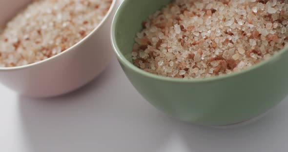 Video of himalayan salt in ceramic bowls on white background