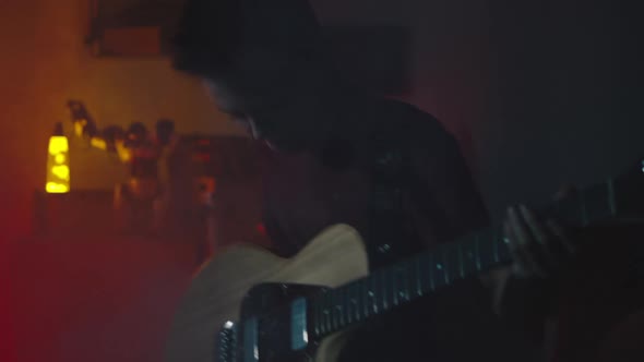 Teen Rocker Playing Guitar in Smoke